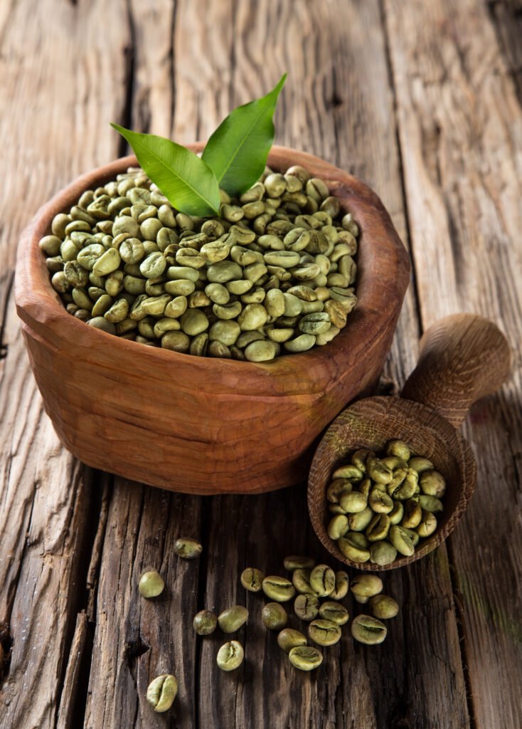 green coffee beans in wooden bowl